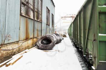 reinforcement rolls near warehouse on railroad station in winter