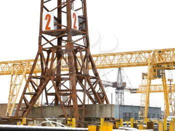 tower and bridge cranes in open air metal product warehouse
