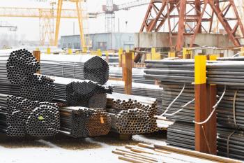 storage of metal pipes in outdoor warehouse with gantry cranes