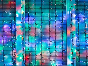 outdoor Christmas garlands decorate window in night
