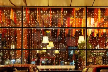 Christmas illumination of restaurant window in night