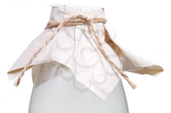 milk bottle closed by brown paper and tied with hemp rope isolated on white background