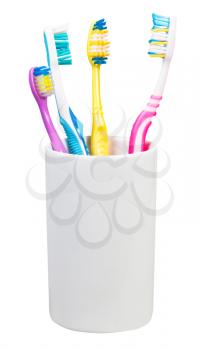 four toothbrushes in ceramic glass - family set of toothbrushes isolated on white background