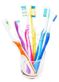 five tooth brushes and interdental brush in clear glass - family set of toothbrushes isolated on white background