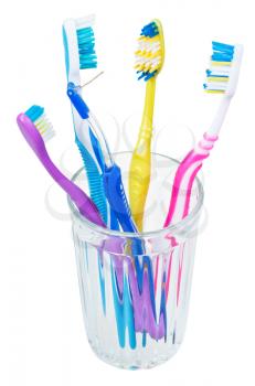 four tooth brushes and interdental brush in glass - family set of toothbrushes isolated on white background