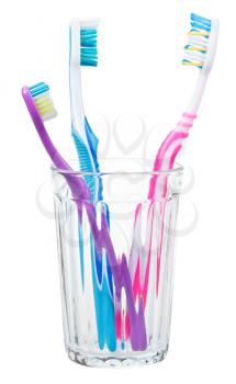 three toothbrushes in glass - family set of toothbrushes isolated on white background
