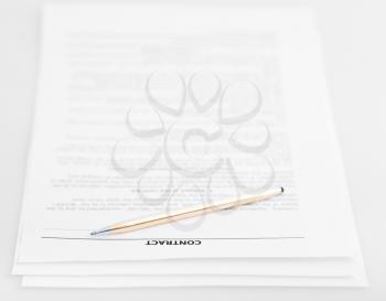 three pages of sales contract and golden pen on white background