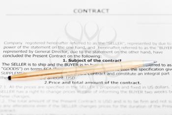golden pen on sheet of sales agreement close up