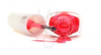 bottle with spilled pink nail polish on white background