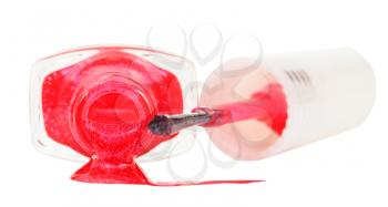 bottle with spilled pink nail polish isolated on white background