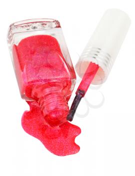 above view of bottle with spilled pink nail polish isolated on white background
