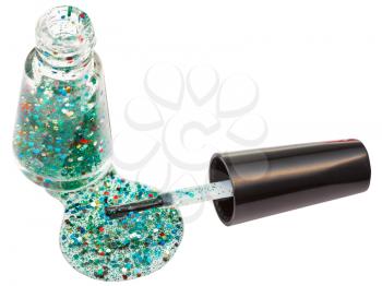 bottle with spilled multicolored glitter nail polish isolated on white background