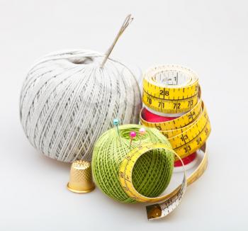 few simple needlework objects on gray background