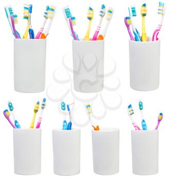collection of tooth brushes in ceramic glases isolated on white background