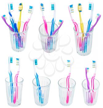 collection of toothbrushes in glases isolated on white background