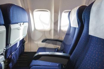 blue seats in economy class passenger section of aircraft