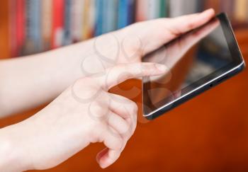 finger clicking touchpad screen in library room