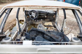 old disassembled car at an automobile junkyard
