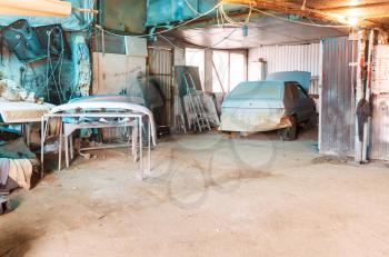 village automobile workshop with old painted car