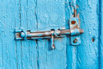 Espagnolette on old blue painted door close up