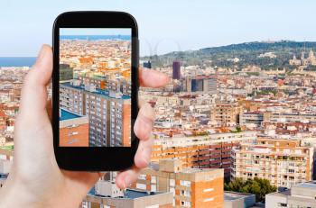travel concept - tourist taking photo of Barcelona skyline on mobile gadget, Spain