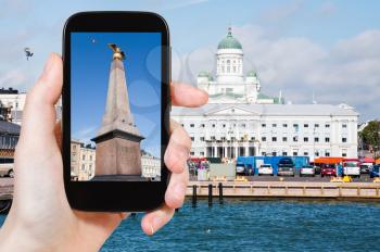 travel concept - tourist taking photo of Market Square, City Hall and Lutheran Cathedral from South Harbour, in Helsinki, Finlandon mobile gadget, Finland