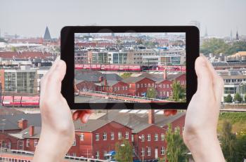 travel concept - tourist taking photo of Copenhagen skyline on mobile gadget, Denmark