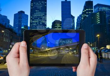 travel concept - tourist taking photo of New York City in night on mobile gadget
