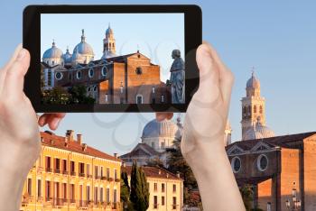 travel concept - tourist taking photo of Basilica of Santa Giustina of Padua, Italy, on mobile gadget