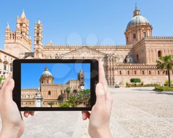 travel concept - tourist taking photo of Cathedral of Palermo, Sicily on mobile gadget, Italy