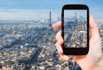travel concept - tourist taking photo Paris skyline with Eiffel Tower afternoon on mobile gadget, France
