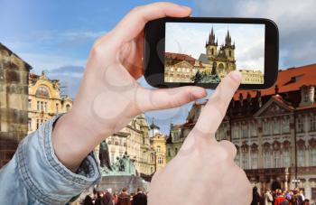 travel concept - tourist taking photo of old town square in Prague on mobile gadget, Czech