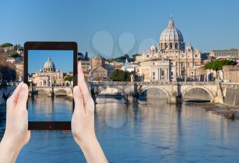 travel concept - tourist taking photo of Rome cityscape with St.Peter Basilica on mobile gadget, Italy