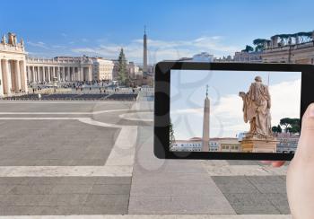 travel concept - tourist taking photo of Egyptian obelisk on St.Peter Square from Piazza Pio, Rome, Italy on mobile gadget
