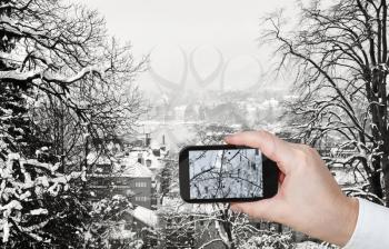 travel concept - tourist taking photo of Zurich city skyline in winter on mobile gadget, Switzerland