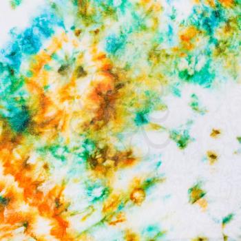 abstract stains of batik painted on white silk close up