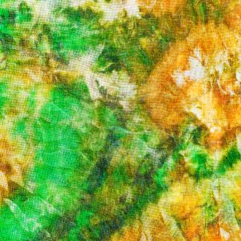 abstract pattern of green yellow batik painted on silk close up