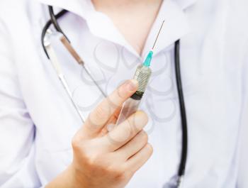 nurse holds syringe close up