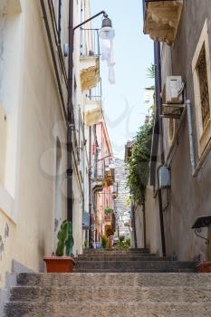 steps on narrow street via Ciraulo in Catania city, Sicily, Italy