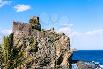 The Castello Normanno in Aci Castello town and Cyclopean Rock (Islands of the Cyclops), Sicily, Italy