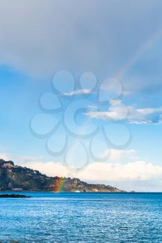 Taormina cape and rainbow in Ionian Sea in spring, Sicily