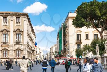 CATANIA, ITALY - APRIL 5, 2015: people at via Etnea and view Etna volcano in Catania city, Sicily, Italy. Etnea is the main street of historical center of Catania, it is about three kilometers long.