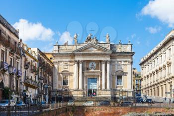 CATANIA, ITALY - APRIL 5, 2015: ancient roman amphitheater (Anfiteatro Romano) and Church San Biagio in Piazza Stesicoro in Catania, Sicily. The arena dates from the 2nd century AD