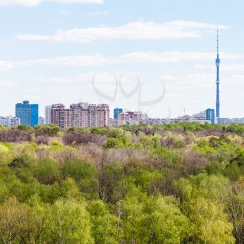 view of city and green woods in spring day