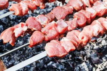 skewers with lamb shish kebabs on brazier close up