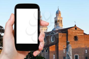 travel concept - tourist photograph view of Basilica of S.Giustina in Padua from Prato della Valle, Italy on smartphone with cut out screen with blank place for advertising logo