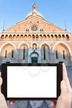 travel concept - tourist photograph facade of Basilica di Sant ' Antonio da Padova in Padua, Italy on tablet pc with cut out screen with blank place for advertising logo