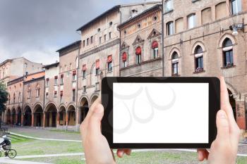 travel concept - tourist photograph Piazza Santo Stefano in autumn day in Bologna, Italy on tablet pc with cut out screen with blank place for advertising logo