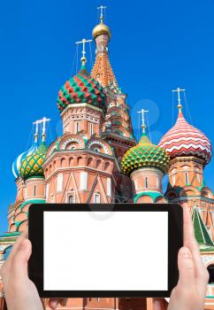 travel concept - tourist photograph Saint Basil's Cathedral in Moscow on tablet pc with cut out screen with blank place for advertising logo
