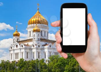 travel concept - tourist photograph Cathedral of Christ the Saviour, Moscow, Russia on smartphone with cut out screen with blank place for advertising logo